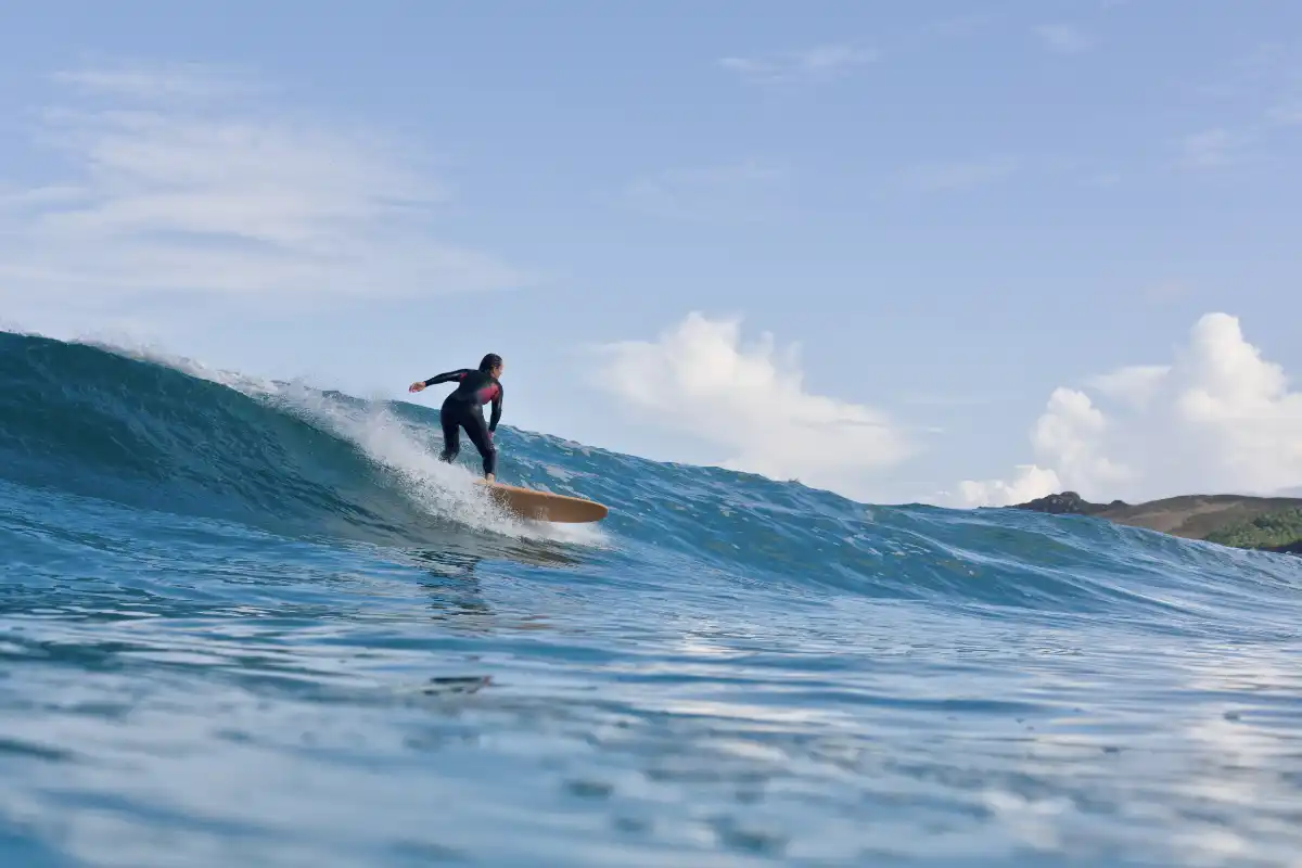 woman surfing on a surf retreat for women in spain